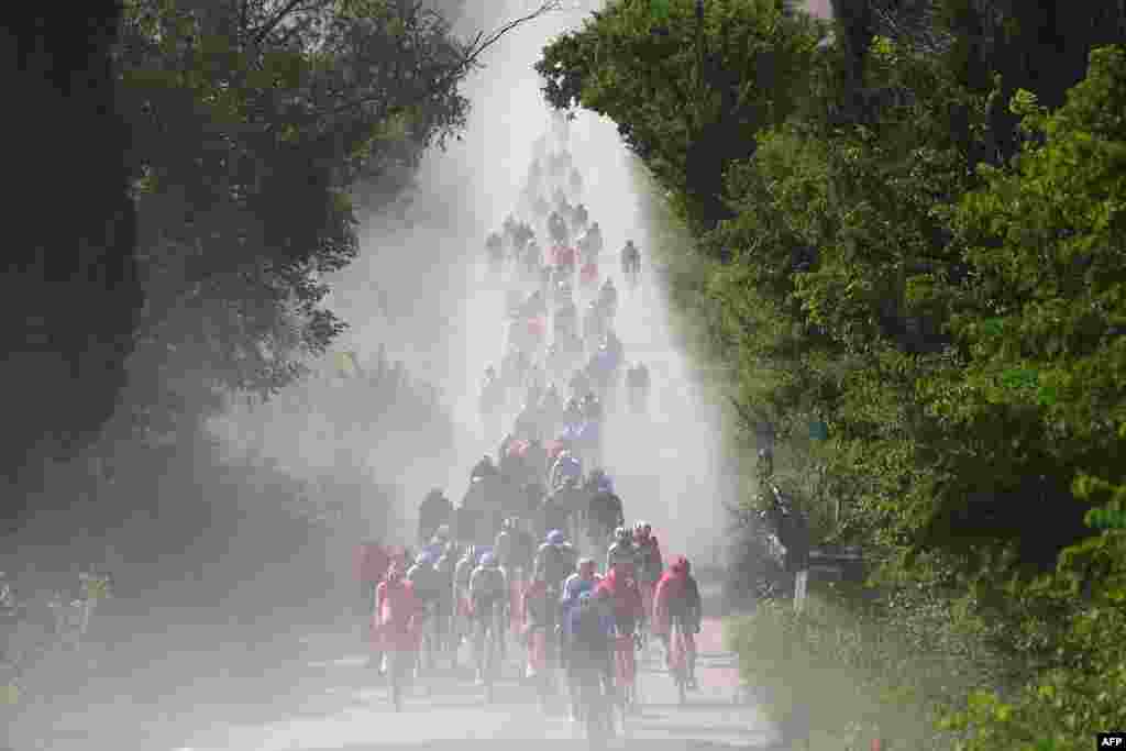 Rombongan pesepeda melintasi jalan putih Tuscany pada etape ke-6 lomba balap sepeda Giro d'Italia ke-107, 180 kilometer antara Torre del lago Puccini dan Rapolano Terme, Italia.