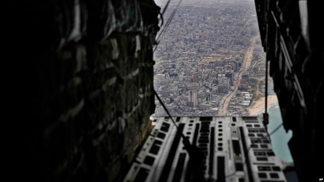 FILE - Containers of humanitarian aid are ready to be dropped from a U.S. C-17 Air Force plane to Palestinians in the Gaza Strip, March 29, 2024. 