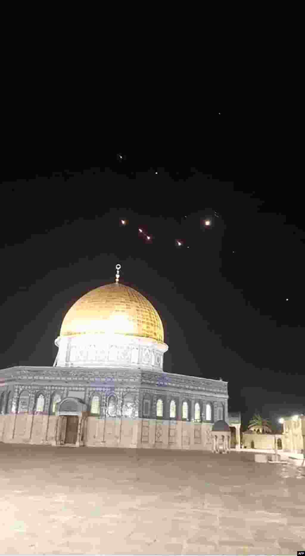 An image-grab from a video taken early on April 14, 2024, shows rocket trails in the sky above the Al-Aqsa Mosque compound in Jerusalem. Iran launched its first-ever direct attack on Israeli territory late on April 13, marking a major escalation of the long-running covert war between the regional foes and sparking fears of a broader conflict breaking out. 