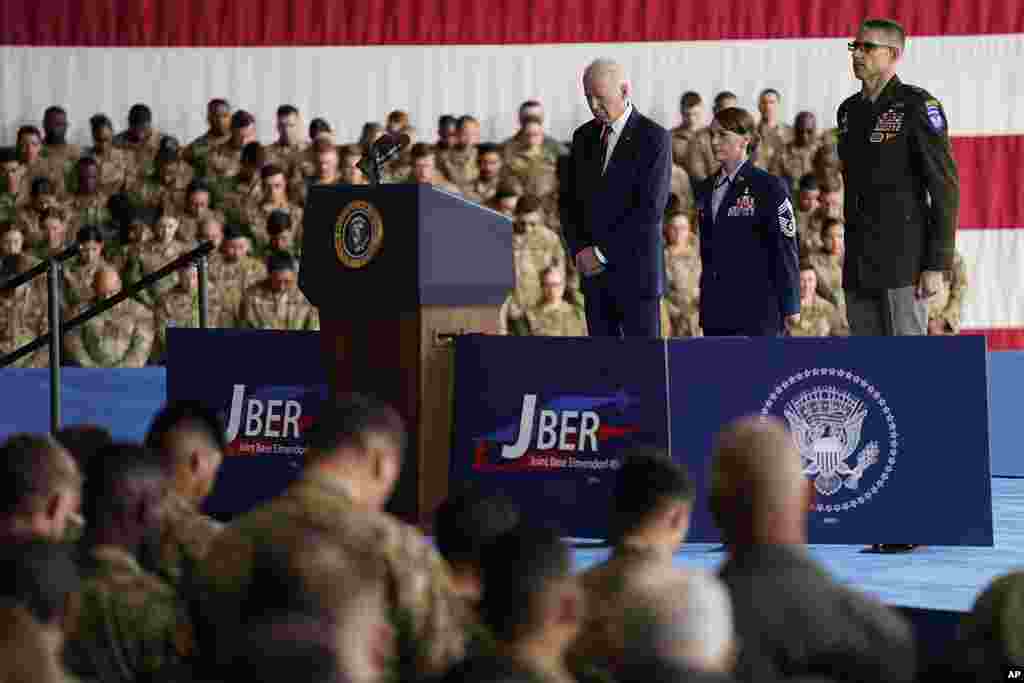 President Joe Biden stands during the playing of "Taps," at Joint Base Elmendorf-Richardson to mark the anniversary of the Sept. 11, 2001, terrorist attacks, in Anchorage, Alaska.