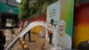 Pekerja kota mencuci jalan dekat papan reklame yang menampilkan Perdana Menteri India Narendra Modi menjelang KTT negara-negara Kelompok 20 minggu ini, di New Delhi, India.