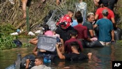FILE - Venezuelan migrants are among those crossing the Rio Grande River, seen from Matamoros, Mexico, May 10, 2023. 