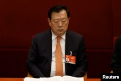 FILE - Xia Baolong, director of the Hong Kong and Macao Affairs Office, attends the Chinese People's Political Consultative Conference at the Great Hall of the People in Beijing, China, March 4, 2021.