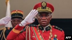 Gabon's General Brice Oligui Nguema (R) salutes as he is inaugurated as Gabon's interim President, in Libreville on Sept. 4, 2023. 