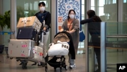 乘坐國際航班抵達北京機場的旅客走出抵達區。（2023年4月26日）