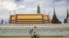 Seorang pendukung kerajaan mengendarai sepedanya yang berhiaskan bendera melewati Grand Palace pada peringatan 70 tahun Raja Thailand Maha Vajiralongkorn di Bangkok pada 28 Juli 2022. (Foto: AFP)