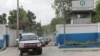 FILE - A convoy of cars carrying members of a Kenyan delegation leave the premises of Haitian National Police after meeting with Frantz Elbe, chief of the Haitian National Police, in Port-au-Prince, Haiti, Aug. 21, 2023. 