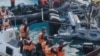 This frame grab from handout video taken on June 17, 2024 shows China coast guard personnel appearing to wield bladed weapons during an incident off Second Thomas Shoal. (Armed Forces of the Philippines - Public Affairs Office/ AFP) 