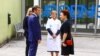 Presiden Prancis Emmanuel Macron (kedua dari kiri), bersama istrinya Brigitte Macron (kiri) disambut Direktur CHU Grenoble Monique Sorrentino (kanan) setibanya di Rumah Sakit Universitas (CHU) di Grenoble, Pegunungan Alpen Prancis, pada 9 Juni 2023. (Benoit Lagneux / POOL / AFP)