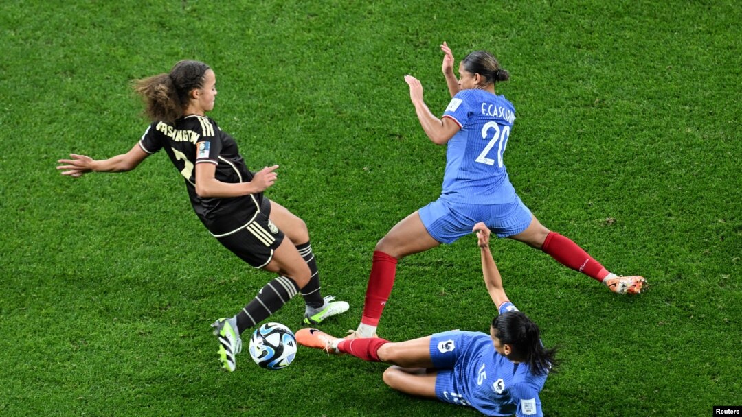 Jamaica's Solai Washington, left, fights for the ball against France's Estelle Cascarino and Kenza Dali during the FIFA Women’s World Cup at Sydney Football Stadium, in Sydney, Australia, July 23, 2023.