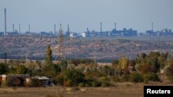 A view shows the Avdiivka Coke and Chemical Plant in the town of Avdiivka as seen from Yasynuvata (Yasinovataya) in the Donetsk region, Russian-controlled Ukraine, Oct. 18, 2023.