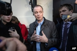 FILE - Russian lawyer Ivan Pavlov, center, is surrounded by journalists after he leaves a court in Moscow, Russia, April 30, 2021.