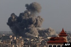 A picture taken from Rafah shows smoke billowing over Khan Younis in the southern Gaza Strip during Israeli bombardment, Jan. 24, 2024.