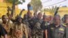 FILE - This picture released on the Sudanese army's Facebook page on May 30, 2023, shows army chief Abdel Fattah al-Burhan cheering with soldiers as he visits some of their positions in Khartoum. 