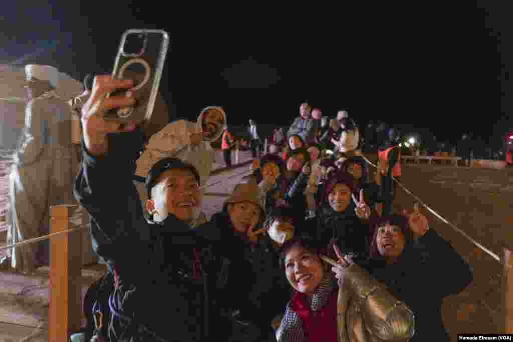 Tourists from Taiwan pose for a group selfie inside the ancient Abu Simbel complex, a longtime UNESCO World Heritage site with two towering rock-carved temples, near the banks of the River Nile, Abu Simbel, Egypt, Feb. 22, 2024.