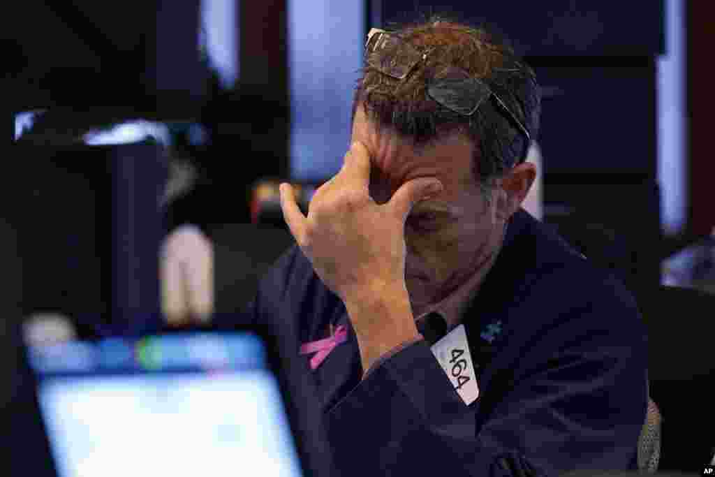 Trader Gregory Rowe works on the floor of the New York Stock Exchange. Nearly everything on Wall Street is tumbling as fear about a slowing U.S. economy worsens and sets off another sell-off for financial markets around the world.