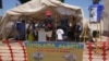 FILE - A family is seen entering a tent set up for suspected cholera patients at a clinic in Harare, Zimbabwe, Nov. 18, 2023.