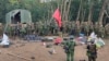 Members of the Myanmar National Democratic Alliance Army are pictured with weapons allegedly seized from the Myanmar's army outpost on a hill in Chinshwehaw town, Oct. 28, 2023.