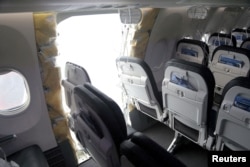 FILE - The fuselage plug area of Alaska Airlines Flight 1282 Boeing 737 Max is seen during its investigation by the National Transportation Safety Board in Portland, Oregon, Jan. 7, 2024. (NTSB/Handout via Reuters)