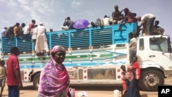FILE - People board a truck as they leave Khartoum, Sudan, on June 19, 2023. The United Nations Security Council adopted a resolution on March 8, 2024, calling for a Ramadan cease-fire in Sudan.