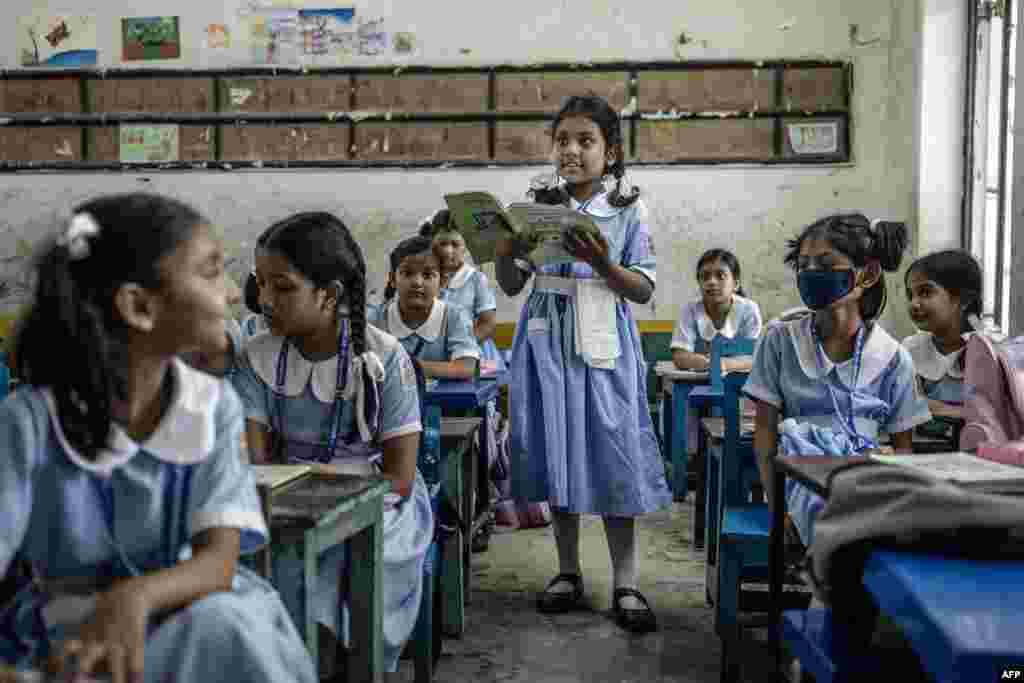 A student reads her textbook in a classroom during the reopening of schools at the Viqarunnisa Noon School and College in Dhaka, Bangladesh, Aug. 18, 2024, after a long halt due to the anti-government protests that resulted in the resignation of Sheikh Hasina.
