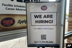 FILE - A hiring sign is displayed at a restaurant in Mount Prospect, Illinois, July 6, 2023.