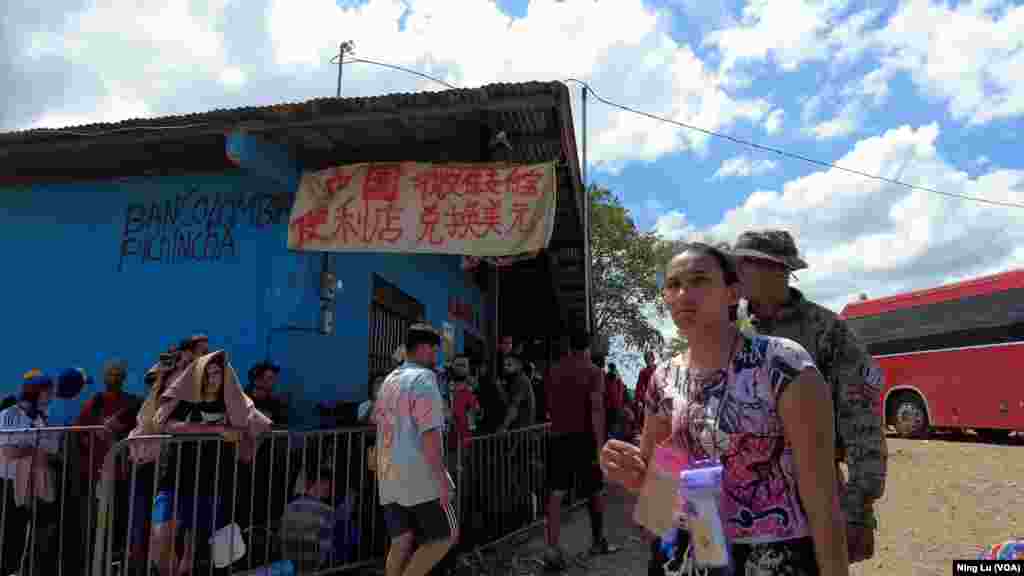 A sign outside a convenience store in Lajas Blancas, Darien Province, Panama, on Feb. 24, 2024, says, “Chinese convenience store, money exchange with WeChat Pay or Zhifubao."
