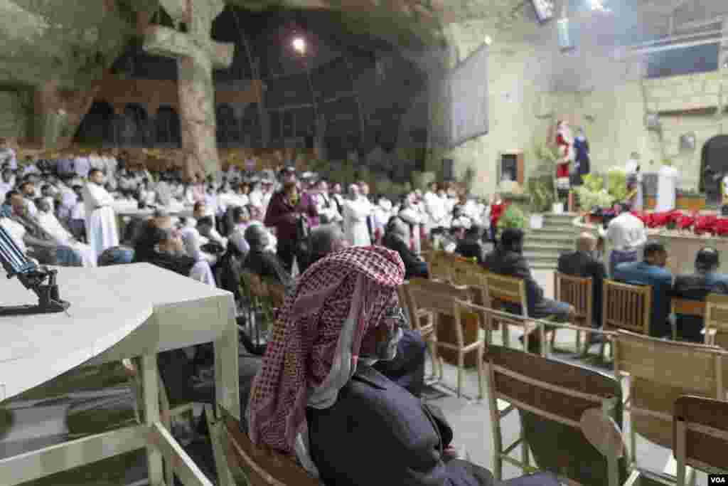 A Coptic man wearing a keffiyeh, or traditional Arab scarf, sits in prayer. Many this Christmas are reflecting on the unprecedented humanitarian crisis across the border in Gaza as Israel's siege shows no signs of letting up. Cairo, Egypt, Jan. 6, 2024.