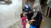 A health worker administers a polio vaccine to a child in Karachi, Pakistan, Nov. 27, 2023.