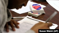 FILE - A student fills out a college enrollment application.