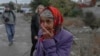 An woman cries in a street after a rocket attack in Mykolaiv, Oct. 23, 2022, during the Russian invasion of Ukraine.