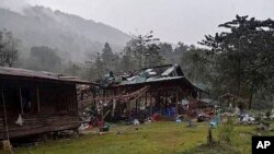 Debris are scattered around destroyed wooden structures near Aung Bar Lay Village, Hpakant township, Kachin state in Myanmar Oct. 24, 2022