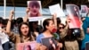 FILE - Protesters gather outside the UN headquarters in Erbil on Sept. 24, 2022, to protest the death of Masha Amini, who had fallen into a coma for three days after being detained by the morality police in Tehran, Iran. 