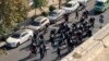 FILE - This frame grab from video taken by an individual not employed by the Associated Press and obtained by the AP outside Iran shows Iranian police dispersing a protest in Tehran, Iran, Oct. 26, 2022. Lawyers providing legal aid to protesters reportedly have been arrested.