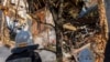 Firefighters work after a drone fired on buildings in Kyiv, Ukraine, Oct. 17, 2022. 