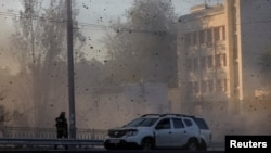 FILE - A view shows flying debris from an explosion in a street during a Russian drone strike, which local authorities consider to be Iranian-made Shahed-136 unmanned aerial vehicles (UAVs), in Kyiv, Ukraine, Oct. 17, 2022. 