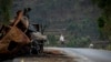 FILE - A man crosses the road near a destroyed truck in the Tigray region of northern Ethiopia, May 11, 2021. 