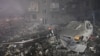A rescuer works at a site of a residential building heavily damaged by a Russian missile strike in Zaporizhzhia, Ukraine, Oct. 10, 2022.