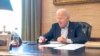 In this image provided by the White House, President Joe Biden speaks on the phone from the Treaty Room in the residence of the White House, July 21, 2022. Biden says he's "doing great" after testing positive for COVID-19. 