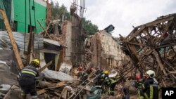 Rescuers remove debris following a Russian missile attack in Chuhuiv, Kharkiv region, Ukraine, July 25, 2022.