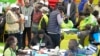 FILE - The Electoral Commission (IEBC) Chairman, Wafula Chebukati, middle in red shirt, and IEBC commissioners at the National Tallying Centre in Bomas of Kenya, Nairobi, Kenya, Aug. 14, 2022.