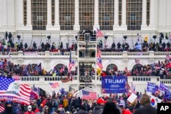 FILE - Insurrectionists loyal to President Donald Trump breach the Capitol in Washington, Jan. 6, 2021.