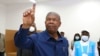 Angola President Joao Lourenco shows his marked finger during the voting process at a polling station in Luanda, Angola, Aug. 24, 2022. 