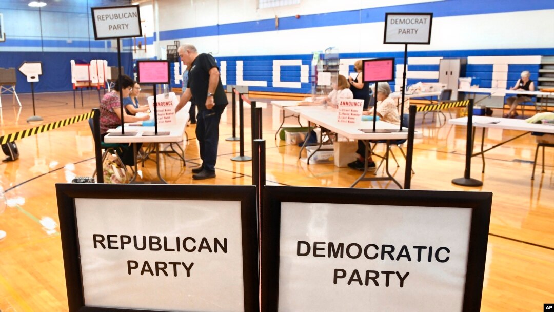 FILE - A voter checks in at Suffield Middle School on primary election day, August 9, 2022, in Suffield, Conn. 