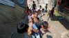FILE - Children from the Rohingya community play outside their shacks in a camp in New Delhi, India, Oct. 4, 2018.