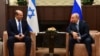 FILE - Russian President Vladimir Putin, right, and Israeli Prime Minister Naftali Bennett speak during their meeting in Sochi, Russia, Friday, Oct. 22, 2021. (Evgeny Biyatov, Sputnik, Kremlin Pool Photo via AP)
