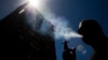 FILE - In this Jan. 18, 2012 photo, a smoker puffs on a cigarette in the central business district in Auckland, New Zealand.