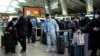 A passenger wearing protective gear is seen at a train station in Beijing on Dec. 28, 2022. 