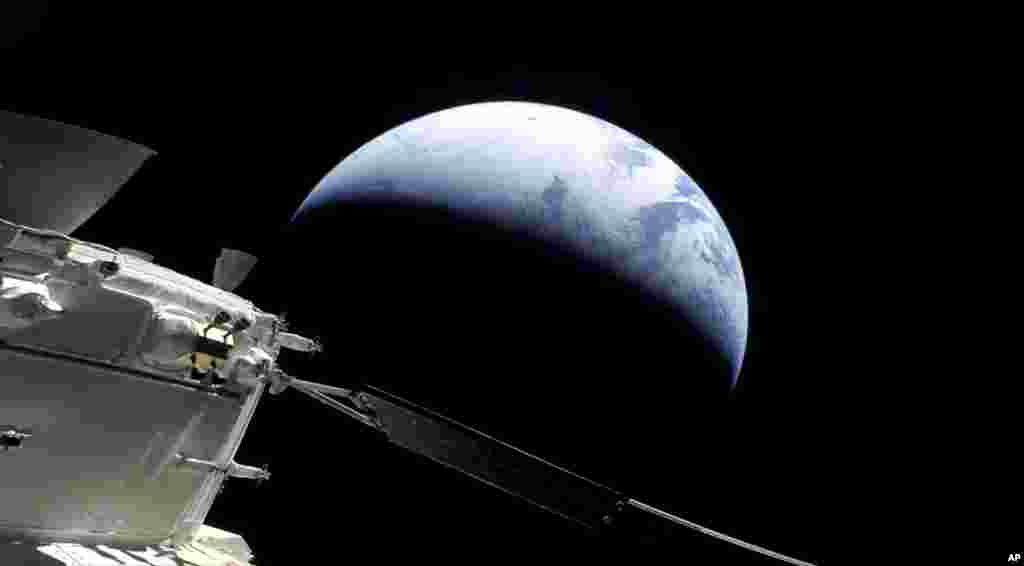 This image provided by NASA shows the Orion spacecraft approaching Earth as it neared the end of its three-week test flight to the moon. 
