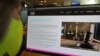 FILE - A woman checks the website of Israel-made Pegasus spyware at an office in the Cypriot capital Nicosia, July 21, 2021. 